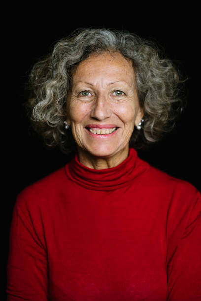 istock Senior Woman Smiling On Black Background 973788360