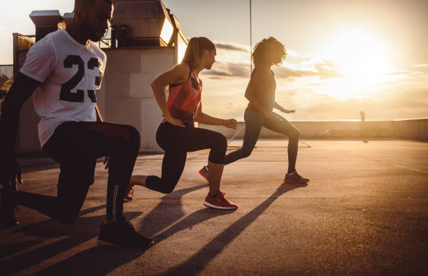 istock Small Group of Athletes Exercising Outdoors 973790638