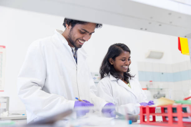 istock Multi-Ethnic Group of Chemists Working in Laboratory Together 973790910