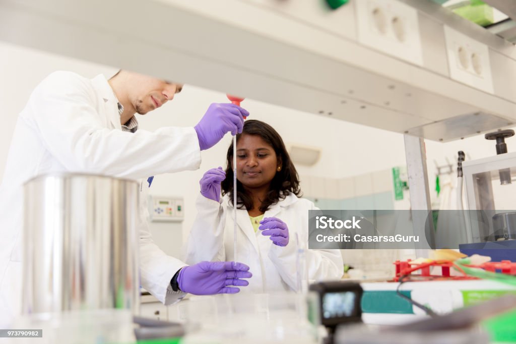 Microchemists Multiethnic Group Of Chemists Using Pipette In Laboratory Stock Photo ...