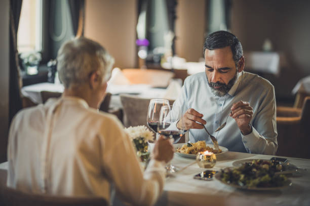 istock Mature couple sitting on a dinner in a restaurant. 973791228
