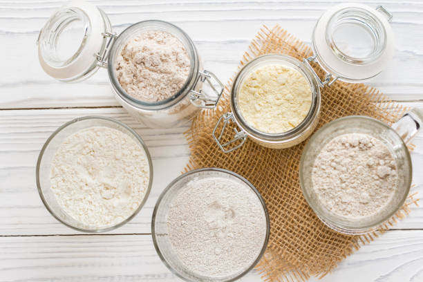 Different flour jars, wheat, corn, rye, oats, spelt, flax stock photo