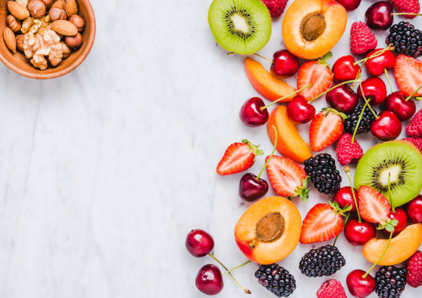 istock Fresh fruits and berries on white marble background. 973833064