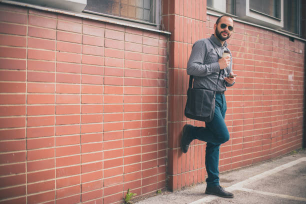 istock Handsome businessman using phone during a coffee break 973836822