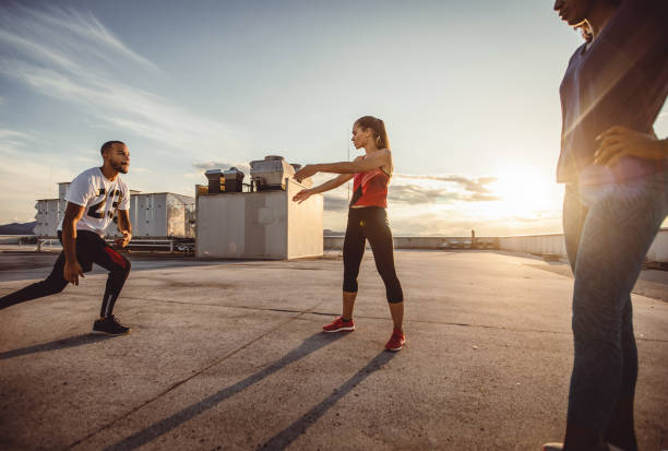 istock Small Group of Athletes Exercising Outdoors 973839152