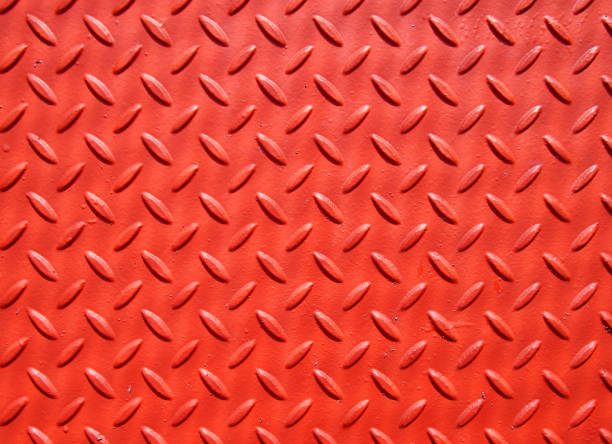 istock red painted industrial metal plate with industrial pattern grip texture 973843744
