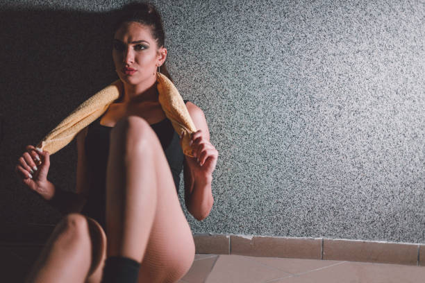 istock Beautiful female dancer relaxing after an exercise in the dance studio 973846306