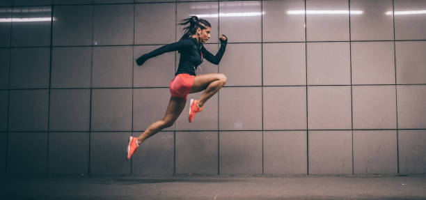istock Woman running at night 973849074