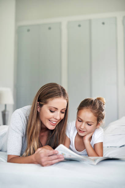 istock The story always sounds better when Mom reads it 973850908