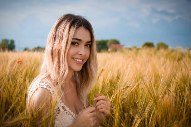 istock Blonde girl in cornfield 973851846