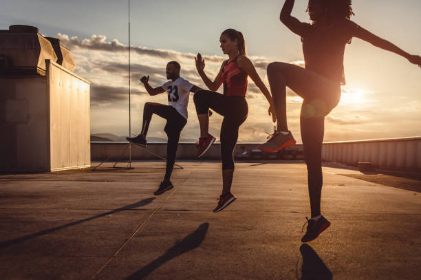 istock Small Group of Athletes Exercising Outdoors 973852008