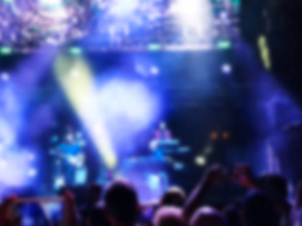 istock Blurred abstract background. Bokeh lighting in concert with audience. 973857668