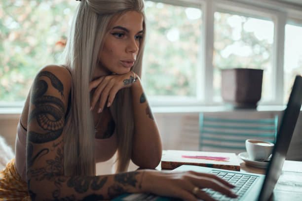 istock Young woman working and using laptop inside the coffee bar 973860530