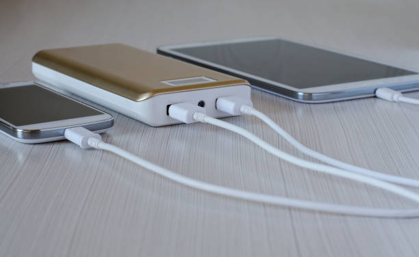 istock Powerbank charges the smartphone and tablet computer. Close up 973861760