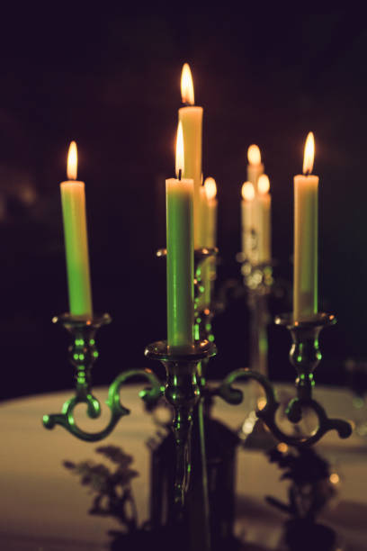 istock Metal retro candlestick with burning candles 973881528