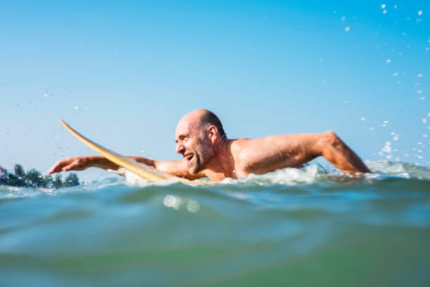 istock A senior man on a surfboard 973891178
