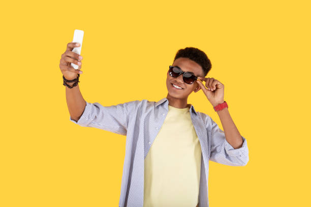 istock Positive pleasant man fixing his sunglasses 973894528