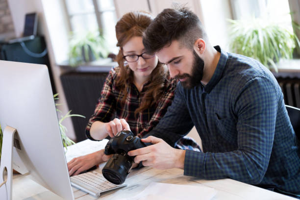 istock Two young designers working in modern office 973900586
