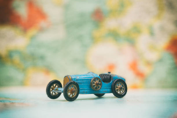 istock Toy Car On Vintage World Map 973906568