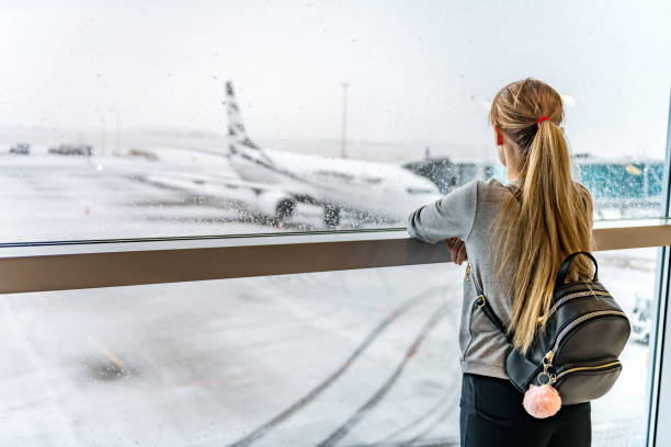 istock Woman looking outdoors & waiting for boarding 973910196