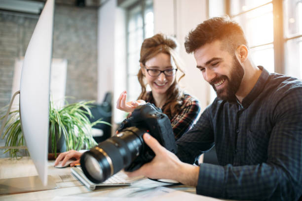 istock Two young designers working in modern office 973910292