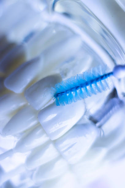 istock Inter dental teeth cleaning brush healthy floss action between each tooth to remove plaque. 973910522