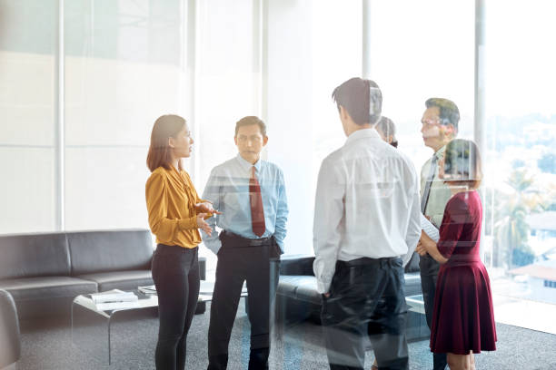 istock Businesswoman explaining team seen through glass 973910726