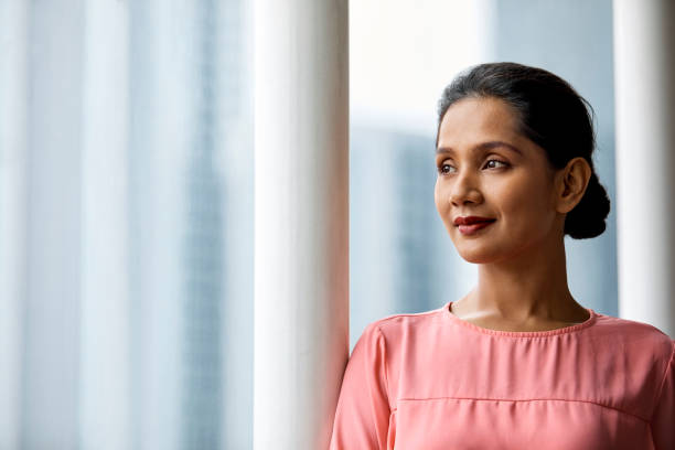 istock Thoughtful businesswoman looking through window 973910994