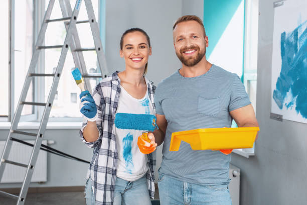 istock Cheerful skilled painters standing together 973912834