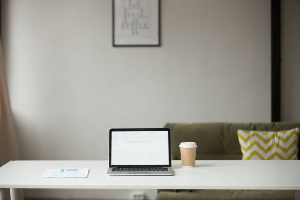 istock Working table with laptop, coffee and documents in home interior 973912930