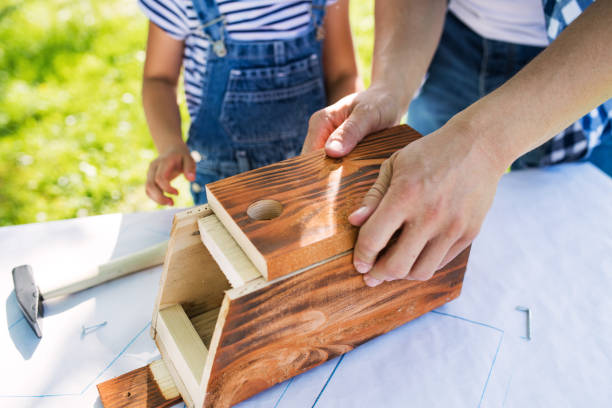 ojciec z małą córką na zewnątrz, co drewniane birdhouse. - men unrecognizable person male hammer zdjęcia i obrazy z banku zdjęć