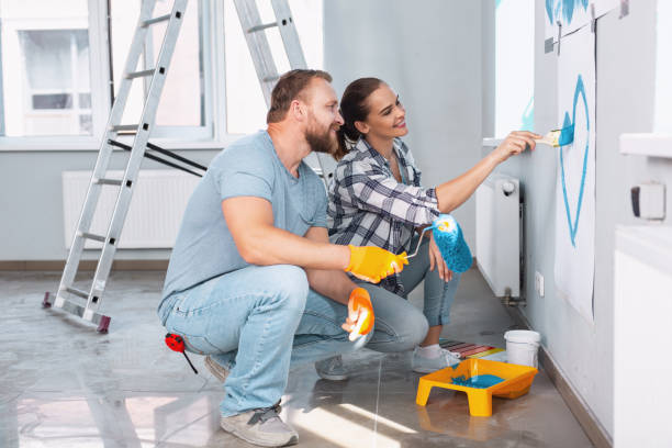 istock Loving couple doing renovations together 973914780