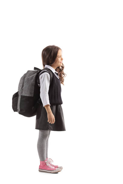 istock Schoolgirl with a backpack waiting in line 973917274