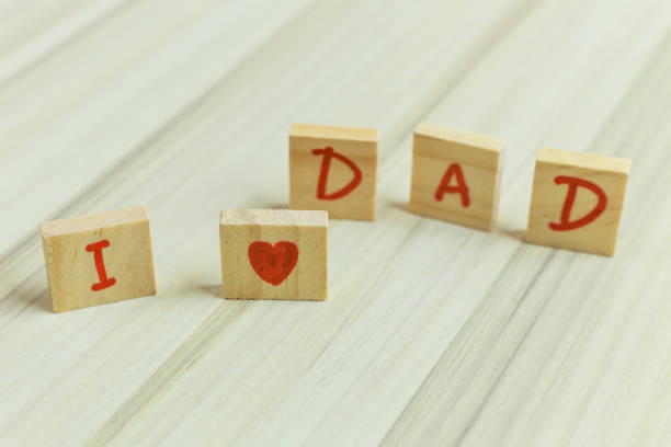 The alphabet on small plate on wood table for Father ’s day image.