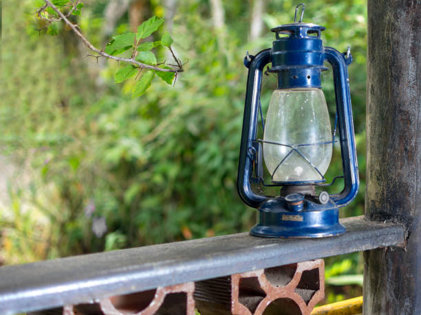 old blue lantern by the porch fence - oil lantern imagens e fotografias de stock