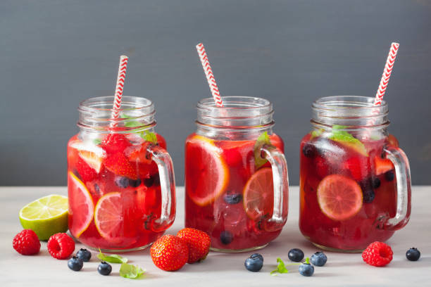 istock summer berry lemonade with lime and mint in mason jar 973925998