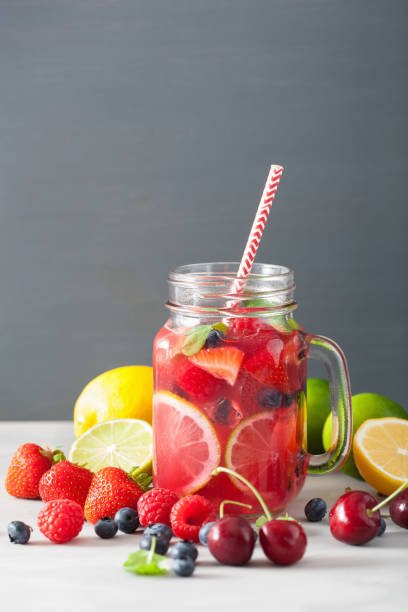 istock summer berry lemonade with lime and mint in mason jar 973926504