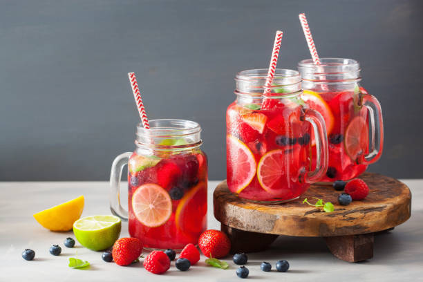 istock summer berry lemonade with lime and mint in mason jar 973927208