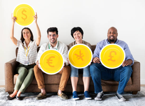istock Diverse workers sitting and holding currency icons 973932426