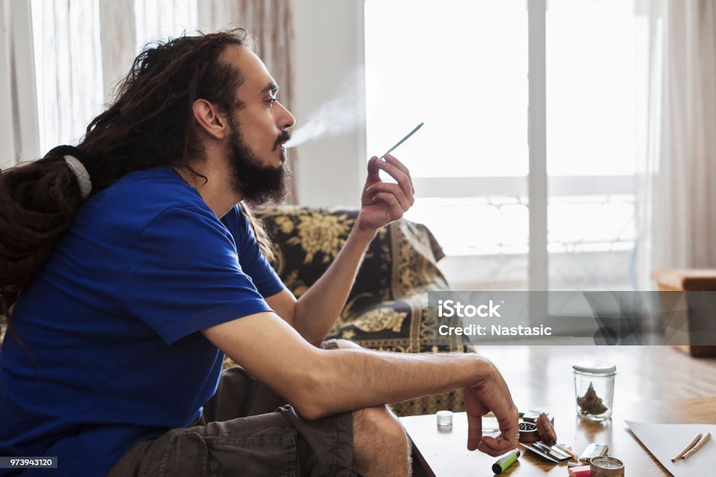 Men smoking marijuana joint Portrait of men smoking marijuana joint Smoking - Activity Stock Photo