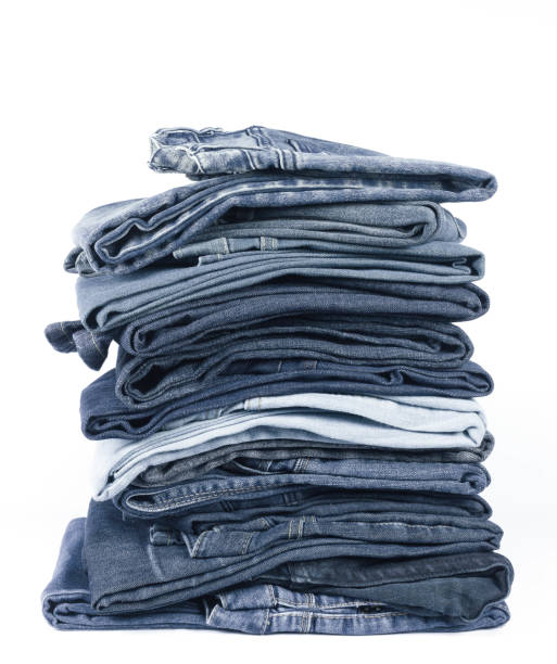 istock jeans stacked isolated on white background. 973957176