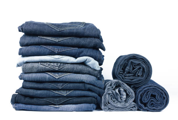 istock jeans stacked isolated on white background. 973957706