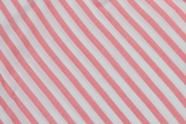 istock Pink and white striped seamless fabric. Close up 973969808