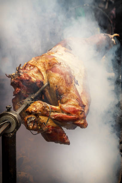 istock Lamb is fried on a spit in the smoke over hot coals 973970048