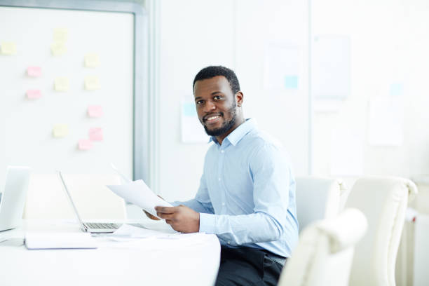 istock Young businessman working with papers 973970732