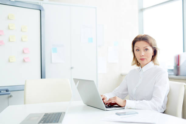 istock Confident businesswoman at workplace 973970856