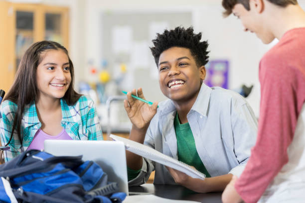 Students brainstorming in science class Diverse group of male and female high school friends brainstorm project ideas or study for an upcoming exam. teenagers only teenager multi ethnic group student stock pictures, royalty-free photos & images