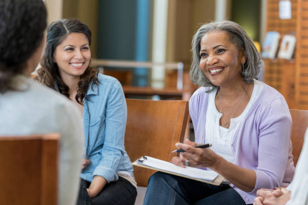 istock Confident businesswoman brainstorms with colleagues 973984388