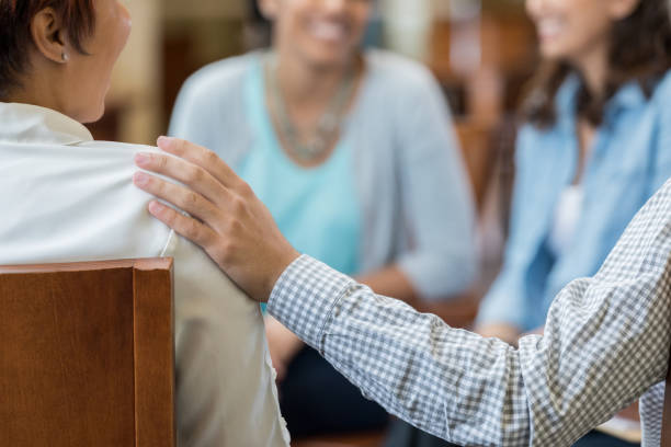 istock Unrecognizable man comforts woman in therapy session 973984412