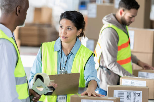 istock Female warehouse manager has serious conversation with coworker 973984906